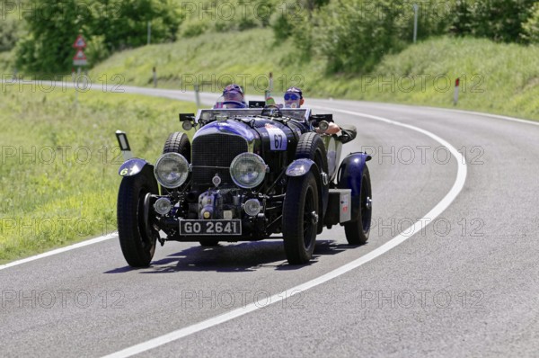 Dark blue classic car with two men on a country road in a green environment, classic car, car race, Mille Miglia, 1000 Miglia, 2015, Tuscany, Rome Lake Garda, Italy