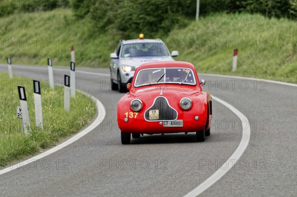 A red classic car is accompanied by a police car on a country road, classic car, car race, Mille Miglia, 1000 Miglia, 2015, Tuscany, Rome Lake Garda, Italy
