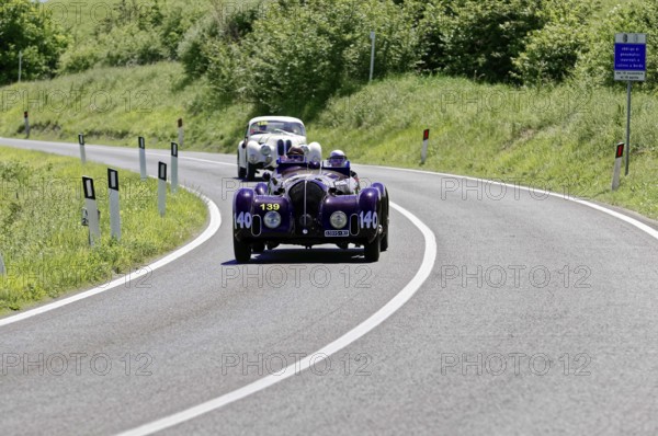 A purple vintage car followed by a white car on a country road, vintage car, car race, Mille Miglia, 1000 Miglia, 2015, Tuscany, Rome Lake Garda, Italy