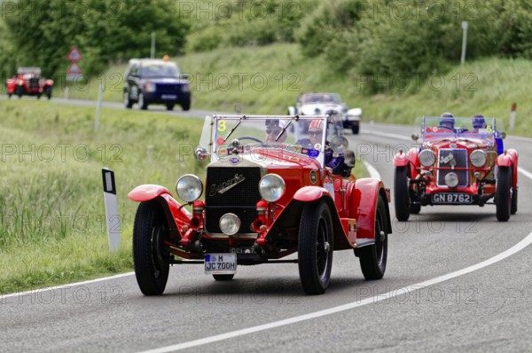 Red classic car in a convoy on a winding country road, classic car, car race, Mille Miglia, 1000 Miglia, 2015, Tuscany, Rome Lake Garda, Italy