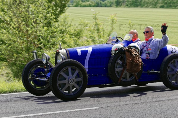 Blue classic car with two men on a country road under a sunny sky, classic car, car race, Mille Miglia, 1000 Miglia, 2015, Tuscany, Rome Lake Garda, Italy