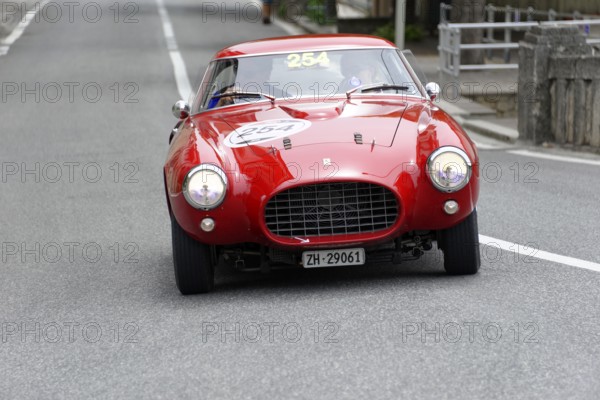 No. 254, Ferrari 250 MM berinetta Pinin Farina, built in 1953, red retro car drives head-on on an empty road, Mille Miglia 2014 or 1000 Miglia, classic car race, San Marino, Italy