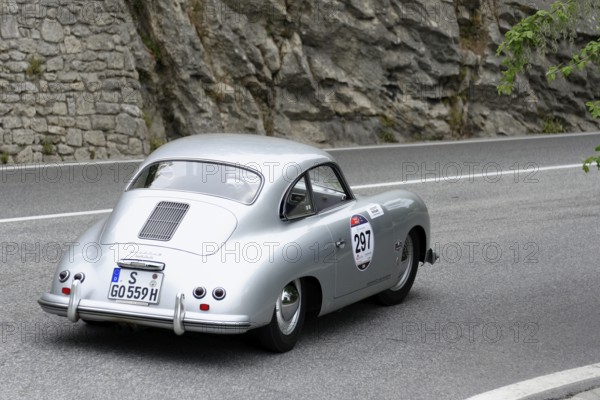 No. 297 Porsche 356 1500 Speedster, model year 1954, Silver vintage car driving on a road along a rocky landscape, Mille Miglia 2014 or 1000 Miglia, vintage car race, San Marino, Italy