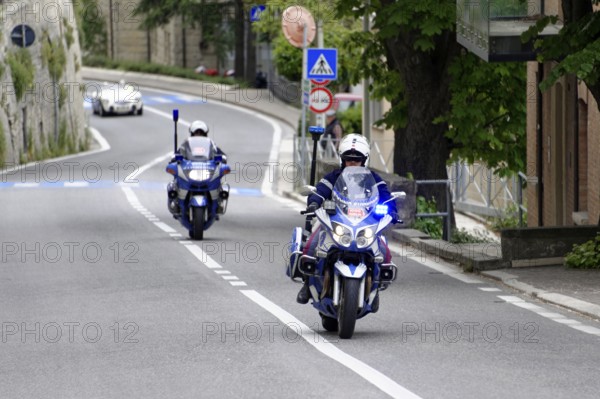 Police motorbikes driving on a road, accompanied by traffic signs, Mille Miglia 2014 or 1000 Miglia, vintage car race, San Marino, Italy