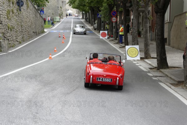 No. 279, Mercedes-Benz 300 SL W 198, model year 1954, red vintage convertible driving on a road lined with cones, Mille Miglia 2014 or 1000 Miglia, vintage car race, San Marino, Italy