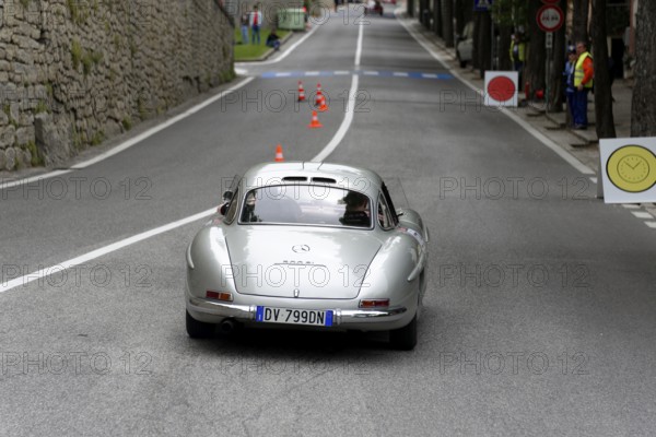 No. 279, Mercedes-Benz 300 SL W 198, model year 1954, silver classic car on a road with cones in a racing environment, Mille Miglia 2014 or 1000 Miglia, classic car race, San Marino, Italy