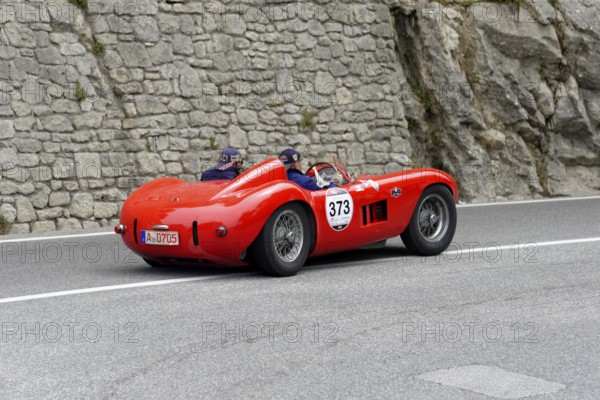 No. 373, Maserati 300 S Fantuzzi, year of construction 1955, Red racing car driving along a winding road with stony scenery, Mille Miglia 2014 or 1000 Miglia, classic car race, San Marino, Italy