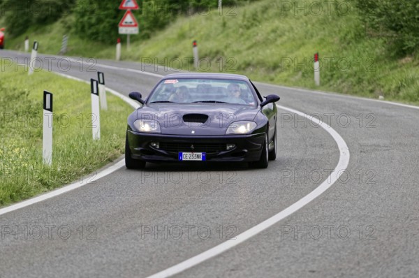 Dark blue sports car on a winding road in a rural setting, classic car, car race, Mille Miglia, 1000 Miglia, 2015, Tuscany, Rome Lake Garda, Italy