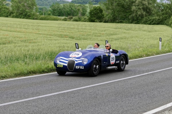 Blue vintage car on country road with green fields and trees in the background, vintage car, car race, Mille Miglia, 1000 Miglia, 2015, Tuscany, Rome Lake Garda, Italy