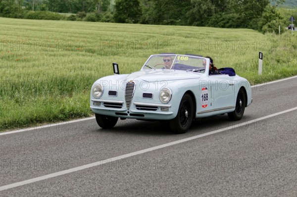 Blue convertible on a country road with green meadows in the background, classic car, car race, Mille Miglia, 1000 Miglia, 2015, Tuscany, Rome Lake Garda, Italy