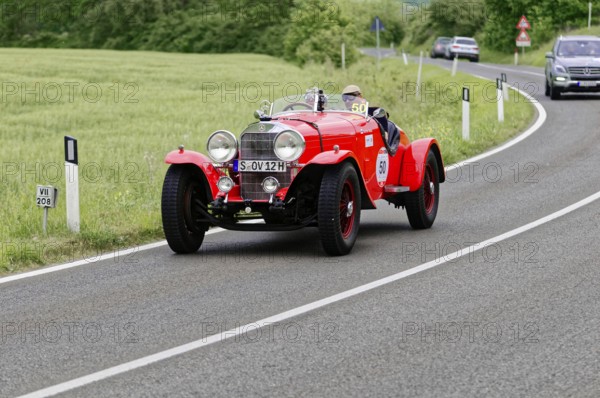 Red vintage car on a country road with green fields and trees, vintage car, car race, Mille Miglia, 1000 Miglia, 2015, Tuscany, Rome Lake Garda, Italy