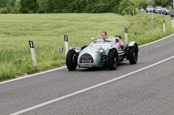 Grey classic car on a country road surrounded by green fields and trees, classic car, car race, Mille Miglia, 1000 Miglia, 2015, Tuscany, Rome Lake Garda, Italy