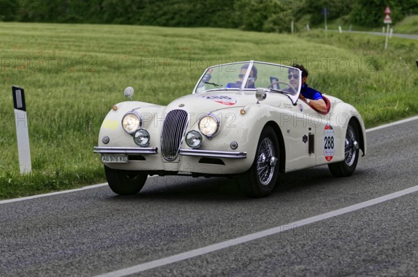 White retro convertible on country road with two people, classic car, car race, Mille Miglia, 1000 Miglia, 2015, Tuscany, Rome Lake Garda, Italy