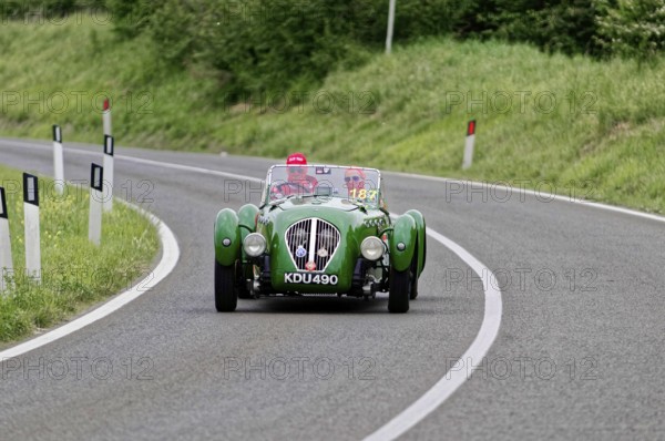 Green classic car driving on a winding country road, classic car, car race, Mille Miglia, 1000 Miglia, 2015, Tuscany, Rome Lake Garda, Italy