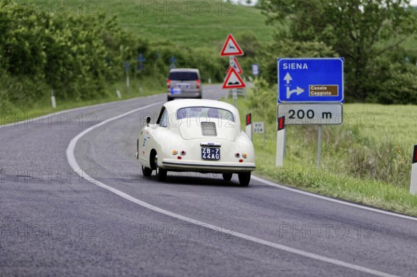 White retro limousine with traffic signs and green landscape, classic car, car race, Mille Miglia, 1000 Miglia, 2015, Tuscany, Rome Lake Garda, Italy