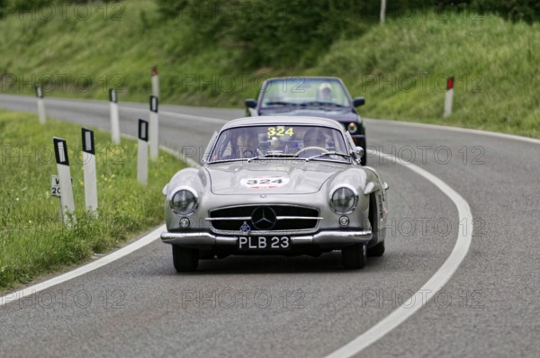 Silver classic car on a winding, rural road accompanied by a blue car, classic car, car race, Mille Miglia, 1000 Miglia, 2015, Tuscany, Rome Lake Garda, Italy