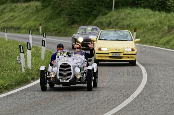 Classic racing car with yellow car in the background on country road, classic car, car race, Mille Miglia, 1000 Miglia, 2015, Tuscany, Rome Lake Garda, Italy