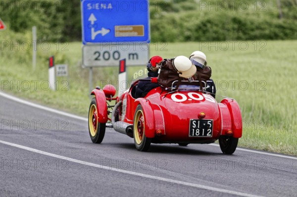 Red classic car on Italian country road towards Siena, classic car, car race, Mille Miglia, 1000 Miglia, 2015, Tuscany, Rome Lake Garda, Italy