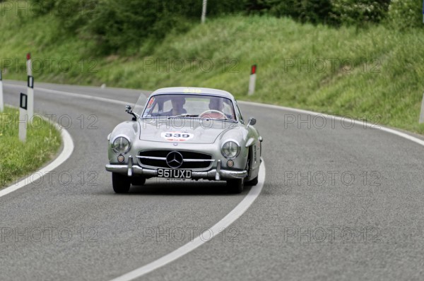 A silver Mercedes classic car drives through a bend, classic car, car race, Mille Miglia, 1000 Miglia, 2015, Tuscany, Rome Lake Garda, Italy
