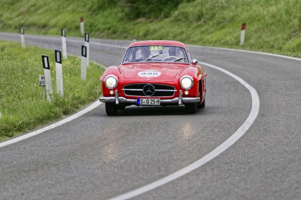 A classic red Mercedes vintage car on a winding country road, classic car, car racing, Mille Miglia, 1000 Miglia, 2015, Tuscany, Rome Lake Garda, Italy