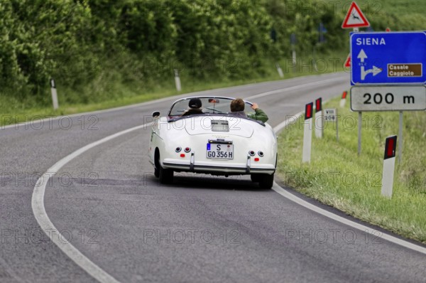 A white vintage convertible on an open country road towards Siena, vintage car, car race, Mille Miglia, 1000 Miglia, 2015, Tuscany, Rome Lake Garda, Italy