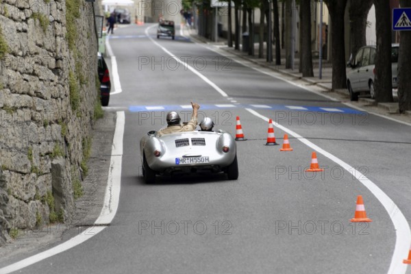 No. 366, Porsche 550 Spyder RS, year of construction 1955, Silver car with two occupants drives through narrow city street past orange traffic cones, Mille Miglia 2014 or 1000 Miglia, classic car race, San Marino, Italy