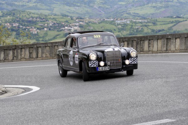 No. 322, Mercedes-Benz 220A, model year 1955, black vintage car driving on a winding road through a mountainous landscape, Mille Miglia 2014 or 1000 Miglia, vintage car race, San Marino, Italy