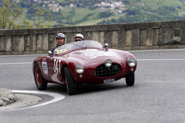 No. 237, Ermini 1100 Sport Motto, built in 1952, red vintage car with helmet-wearing occupants on a winding road, Mille Miglia 2014 or 1000 Miglia, vintage car race, San Marino, Italy