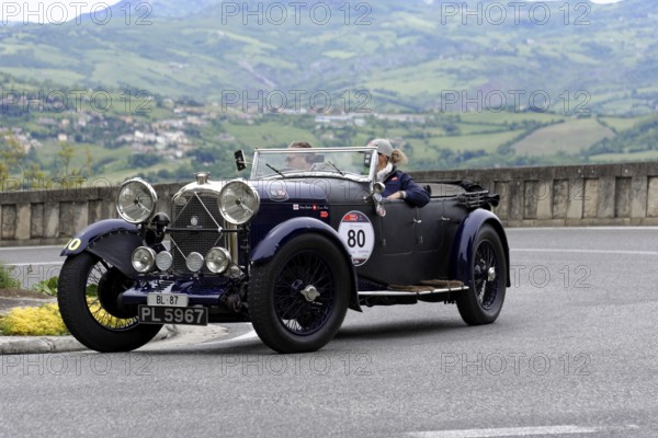 No. 80, Lagonda T2 2, 0 Super Charged, built in 1931, black vintage car with open top and dogs, driving on a winding road in a hilly landscape, Mille Miglia 2014 or 1000 Miglia, vintage car race, San Marino, Italy