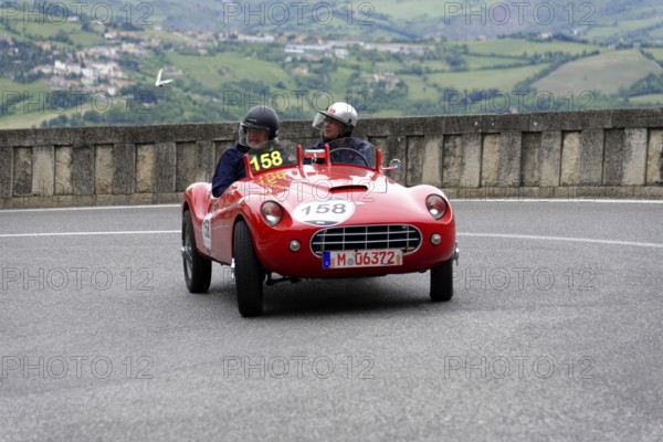 Stanguellini 1100 Sport, built in 1948, red vintage sports car with two occupants on a winding road, Mille Miglia 2014 or 1000 Miglia, vintage car race, San Marino, Italy