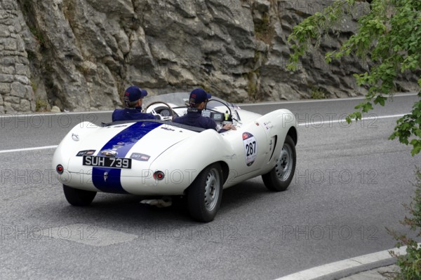 No. 287, Arnolt Bristol Bolide, built in 1954, white vintage car with blue racing stripes drives on a winding road, Mille Miglia 2014 or 1000 Miglia, vintage car race, San Marino, Italy