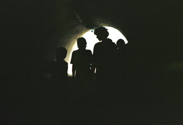 BIH, Sarajevo, 01.09.1995 -- Passers-by walk through an underpass in Sarajevo. During the war years, this underpass served as a bunker for people and artillery. -- Citizens crossing a tunnel, that connects two parts of the city Sarajevo. The tunnel has been used as a shelter and for Bosnian tanks.   Bosnia Hercogovina, Eastern Europe