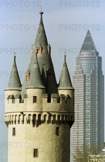 Frankfurt/Main, DEU, 01.07.1994 -- Visual comparison between the Bockenheimer Warte tower and the Frankfurt Messeturm. -- The old Bockenheim tower, left, with Frankfurt's fair tower right in the background.