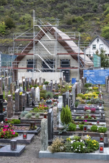 Reconstruction in the Ahr Valley, after the flood of July 2021, buildings that have not yet been renovated or demolished can be found in many places, but most buildings have now been repaired or rebuilt, restored cemetery, new cemetery hall under construction, near Altenahr, Rhineland-Palatinate