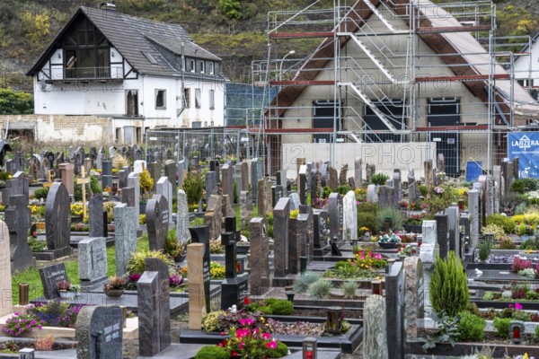 Reconstruction in the Ahr Valley, after the flood of July 2021, buildings that have not yet been renovated or demolished can be found in many places, but most buildings have now been repaired or rebuilt, restored cemetery, new cemetery hall under construction, near Altenahr, Rhineland-Palatinate