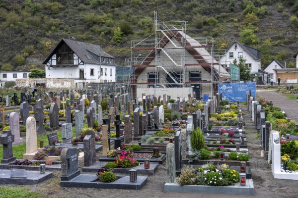 Reconstruction in the Ahr Valley, after the flood of July 2021, buildings that have not yet been renovated or demolished can be found in many places, but most buildings have now been repaired or rebuilt, restored cemetery, new cemetery hall under construction, near Altenahr, Rhineland-Palatinate