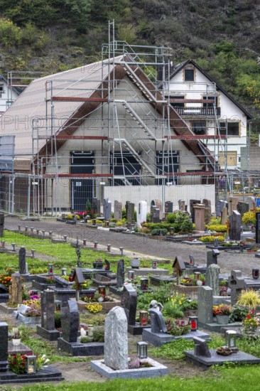 Reconstruction in the Ahr Valley, after the flood of July 2021, buildings that have not yet been renovated or demolished can be found in many places, but most buildings have now been repaired or rebuilt, restored cemetery, new cemetery hall under construction, near Altenahr, Rhineland-Palatinate