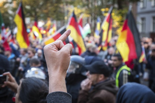 DEU Germany Germany Berlin Right demonstration 'We for Germany' passes through Berlin-Mitte. A counter demonstrator shows the middle finger