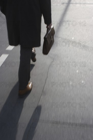 Man with briefcase crosses pedestrian traffic light in Friedrichsstraße