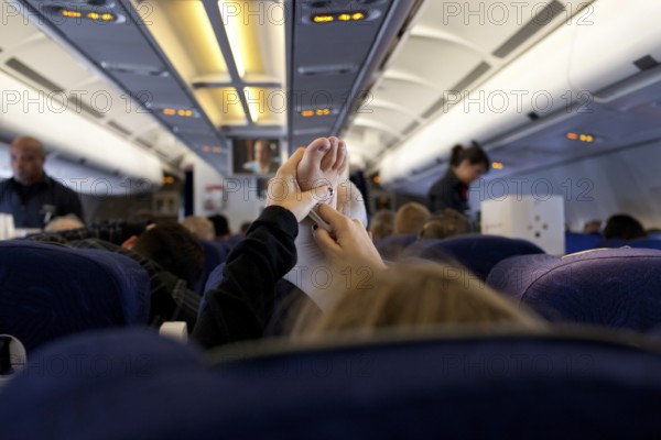 DEU Germany Berlin A passenger stretches her support stocking during an Air Berlin flight to the Thai capital Bangkok. Germany Berlin A passenger stretches her foot in the cabin of an Air Berlin aircarft during the flight to Bangkok