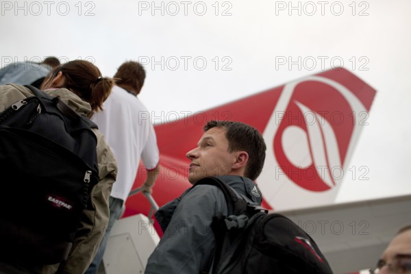 DEU Germany Berlin Passengers board an Air Berlin aircraft on the runway at Berlin-Tegel Airport. Your destination is the Thai capital Bangkok Germany Berlin Passengers embark on Air Berlin aircraft at Tegel Airport