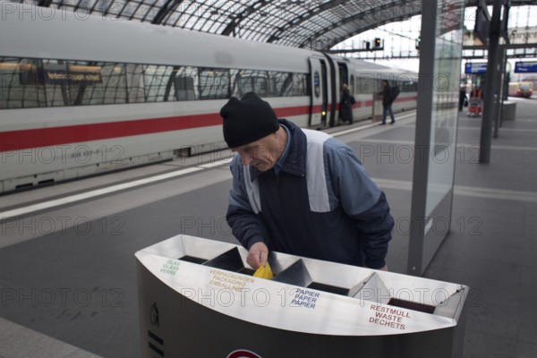 Berlin 2010-11-24 A man searches for recyclable materials in trash cans at Berlin Central Station. DEU Berlin 2010-11-24 A man searches the garbage at Berlin's main station