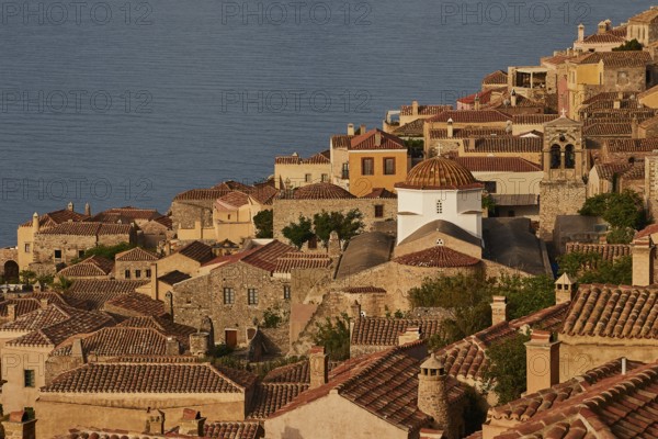 Soft morning light, Holy Church of the Virgin Mary Myrtidiotissa (or Critikias), picturesque town with churches and traditional roofs sloping towards the sea, Monemvasia, Monemvassia, Malvasy, small Byzantine town, rocky island, fortress, Laconia, Peloponnese, peninsula, Greece