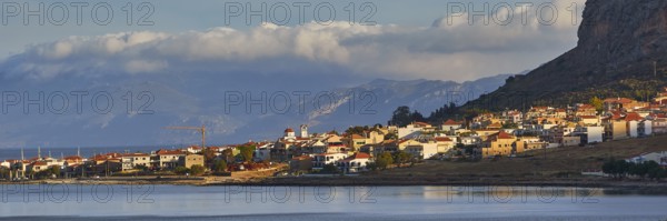Coastal town at dusk with mountains and cloudy sky, Monemvasia, Monemvassia, Malvasy, Byzantine small town, rocky island, fortress, Laconia, Peloponnese, peninsula, Greece