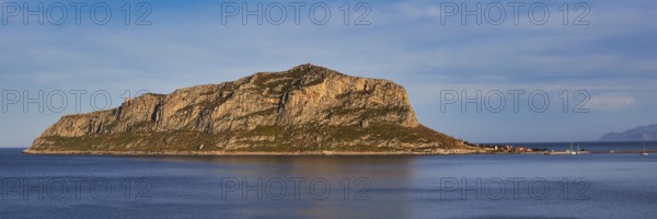 Massive rocky island juts out of the still sea in the afternoon, Monemvasia, Monemvassia, Malvasy, Byzantine small town, rocky island, fortress, Laconia, Peloponnese, peninsula, Greece