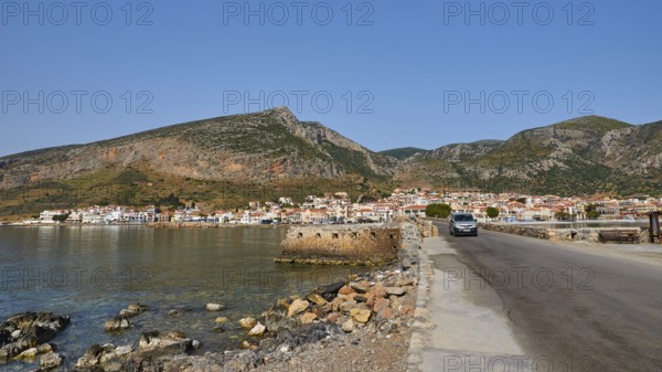 Road leads along the coast of a town against a mountainous backdrop, Monemvasia, Monemvassia, Malvasy, Byzantine small town, rocky island, fortress, Laconia, Peloponnese, peninsula, Greece
