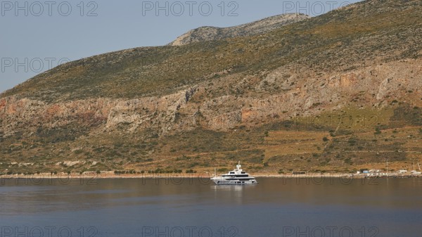 Yacht on calm water in front of a landscape with rocky mountains, Monemvasia, Monemvassia, Malvasy, Byzantine small town, rocky island, fortress, Laconia, Peloponnese, peninsula, Greece