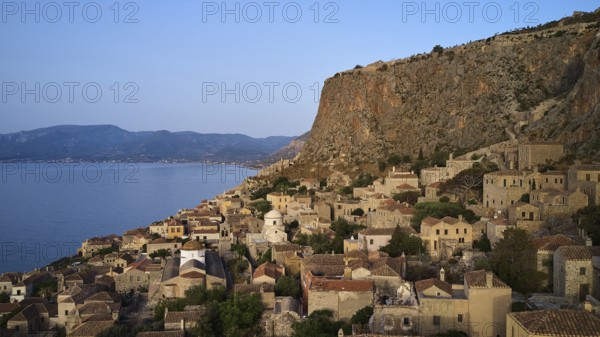 Drone shot, steep cliff with traditional village architecture and sea view, Monemvasia, Monemvassia, Malvasy, small Byzantine town, rocky island, fortress, Laconia, Peloponnese, peninsula, Greece
