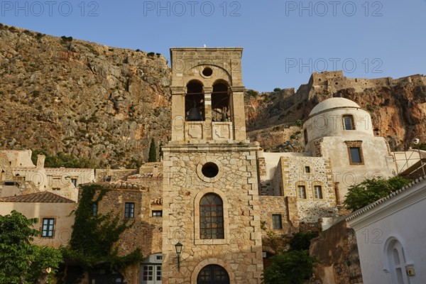Holy Church of Christ in Chains, Elkomenos Christos, Historic Bell Tower and other buildings with large windows in front of a rock wall, Monemvasia, Monemvassia, Malvasy, Byzantine small town, rocky island, fortress, Laconia, Peloponnese, peninsula, Greece
