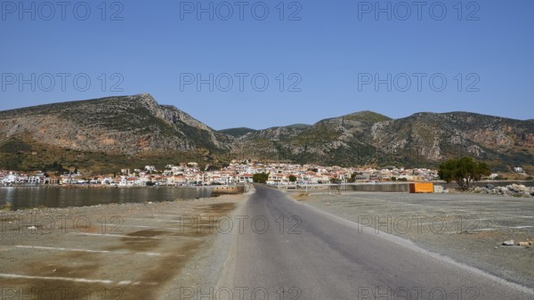 Paved road leads to a seaside town with mountains in the background, Monemvasia, Monemvassia, Malvasy, Byzantine small town, rocky island, fortress, Laconia, Peloponnese, peninsula, Greece